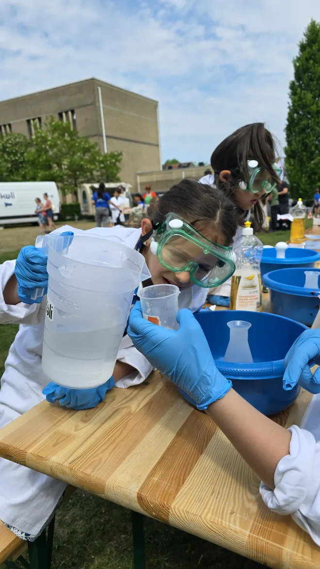 Girl doing a science experiment in a lab coat
